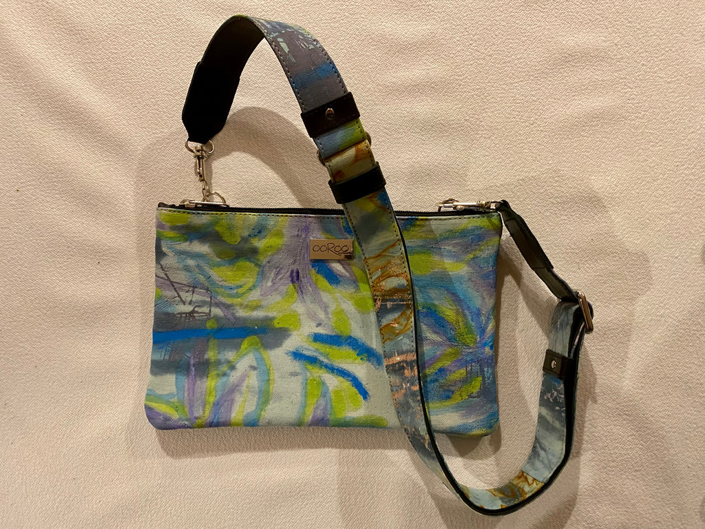 Zara crossbody bag featuring  Chaotic Collage  by artist Anna Reynolds.