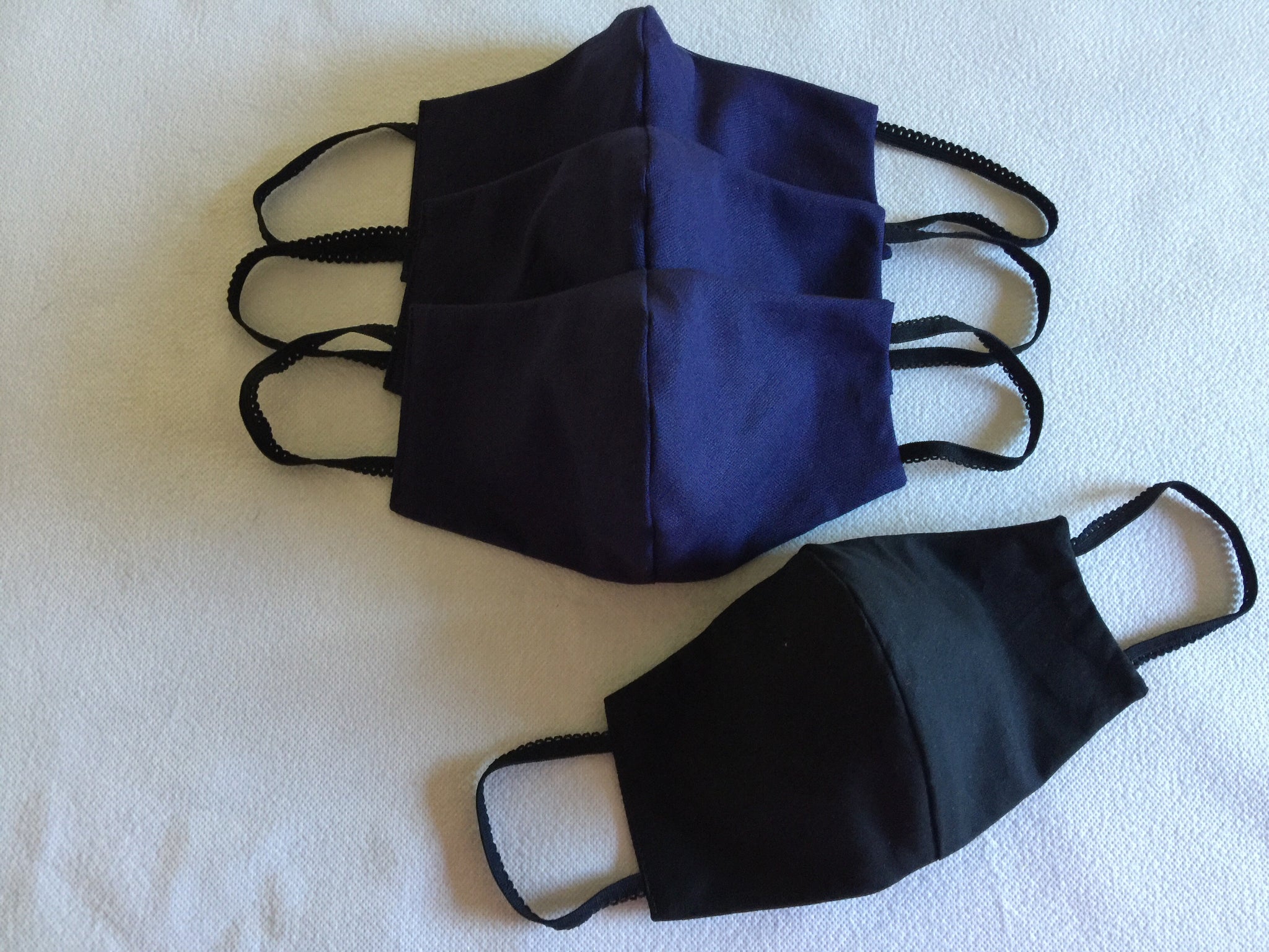 Face mask featuring navy linen with a black cotton reversable option .